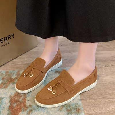 Zamszowe damskie lofersy na płaskiej, jasnej podeszwie z ozdobną przywieszką, dostępne w szerokiej gamie kolorystycznej.