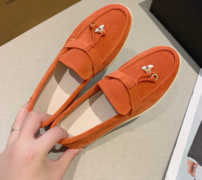 Zamszowe damskie lofersy na płaskiej, jasnej podeszwie z ozdobną przywieszką, dostępne w szerokiej gamie kolorystycznej.