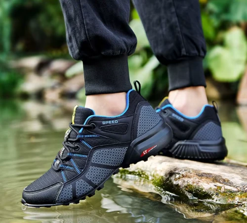 Męskie buty trekkingowe z dynamicznym wzorem bocznych pasów i traperową podeszwą, dostępne w kolorze czarnym i szarym z kolorowymi detalami w rozmiarach 39-47.